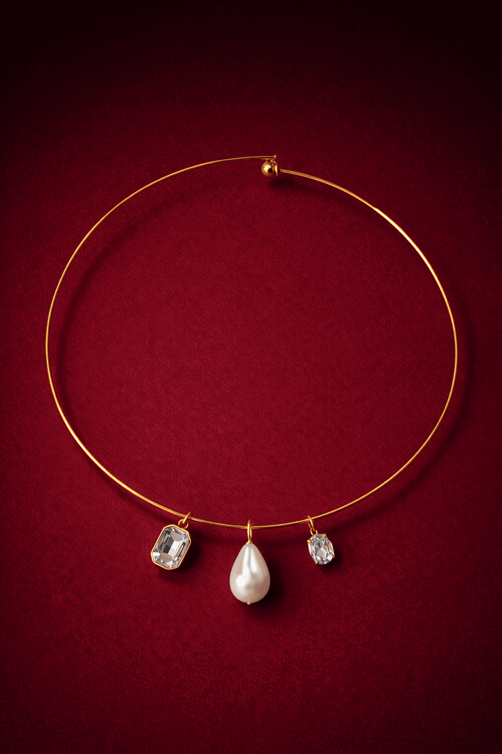 Gold necklace with three pendant stones on a red background, Trio Cuff Necklace by VINTARAS.