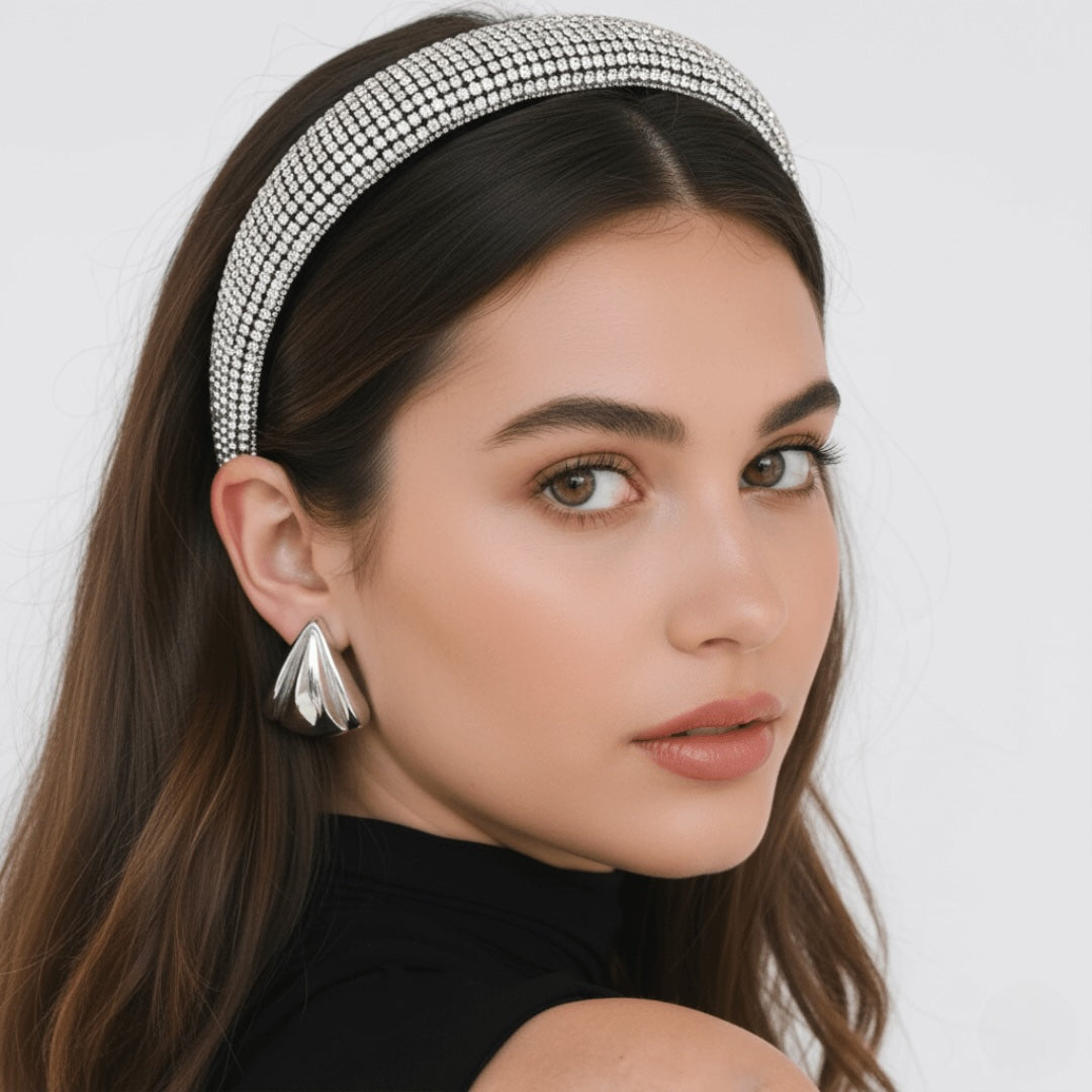 Woman wearing a sparkling headband - VINTARAS BAROQUE RHINESTONE HEADBAND and vintage earrings against a white background