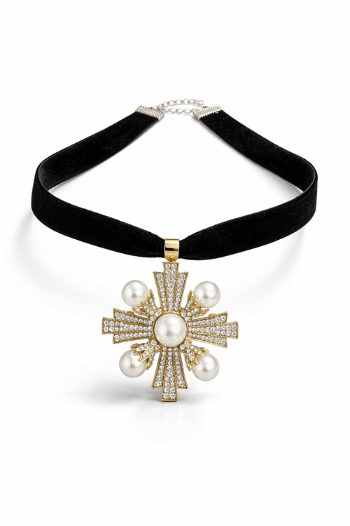 Cross-shaped pendant featuring pearls and small crystals on a black velvet necklace