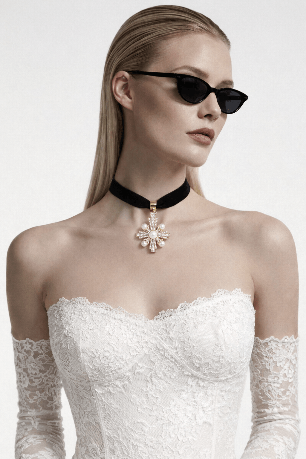 Cross-shaped pendant featuring pearls and small crystals on a black velvet necklace