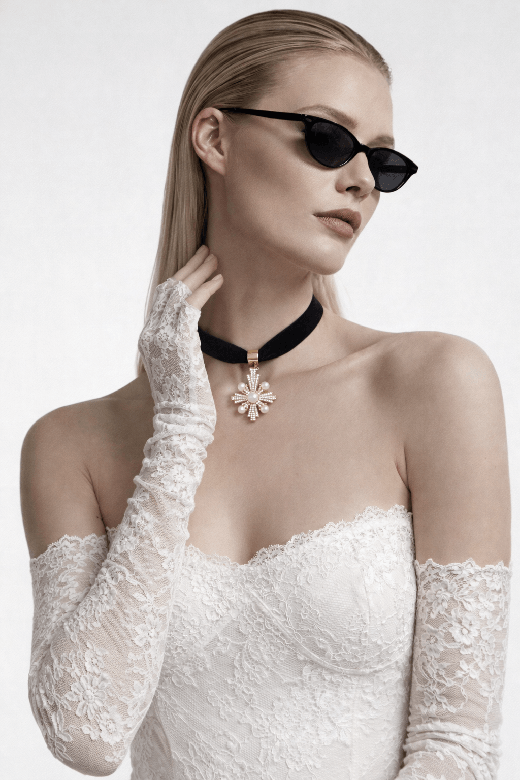 Cross-shaped pendant featuring pearls and small crystals on a black velvet necklace