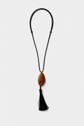 Necklace with a wooden pendant and black tassel on a white background