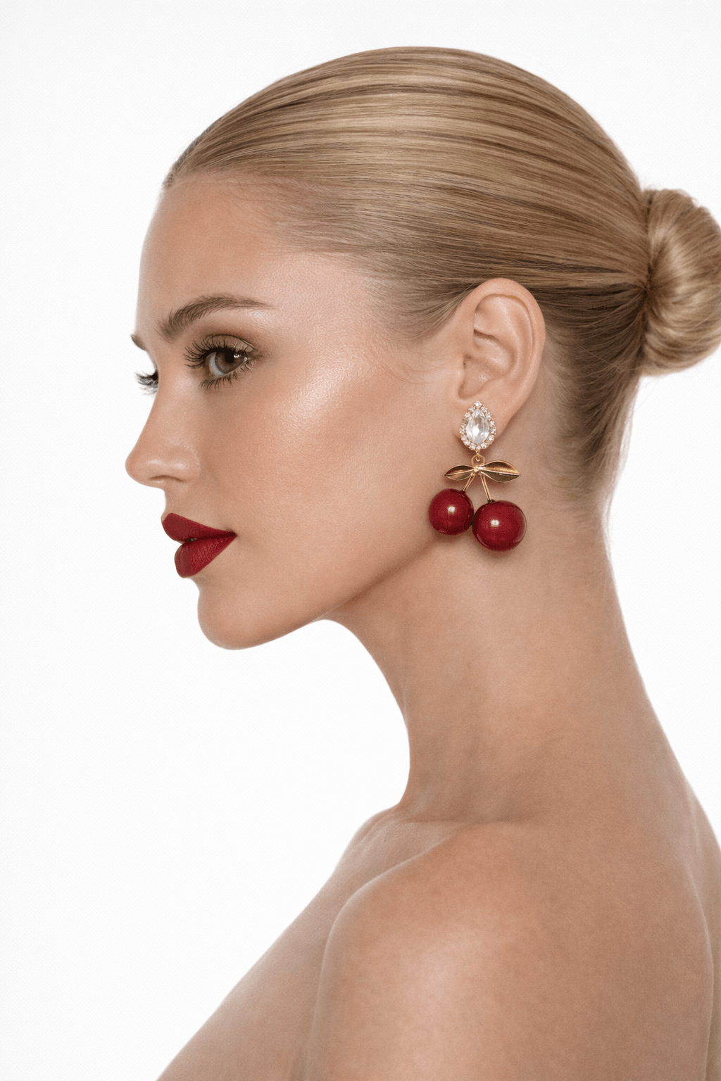 Woman wearing red earrings with a white background