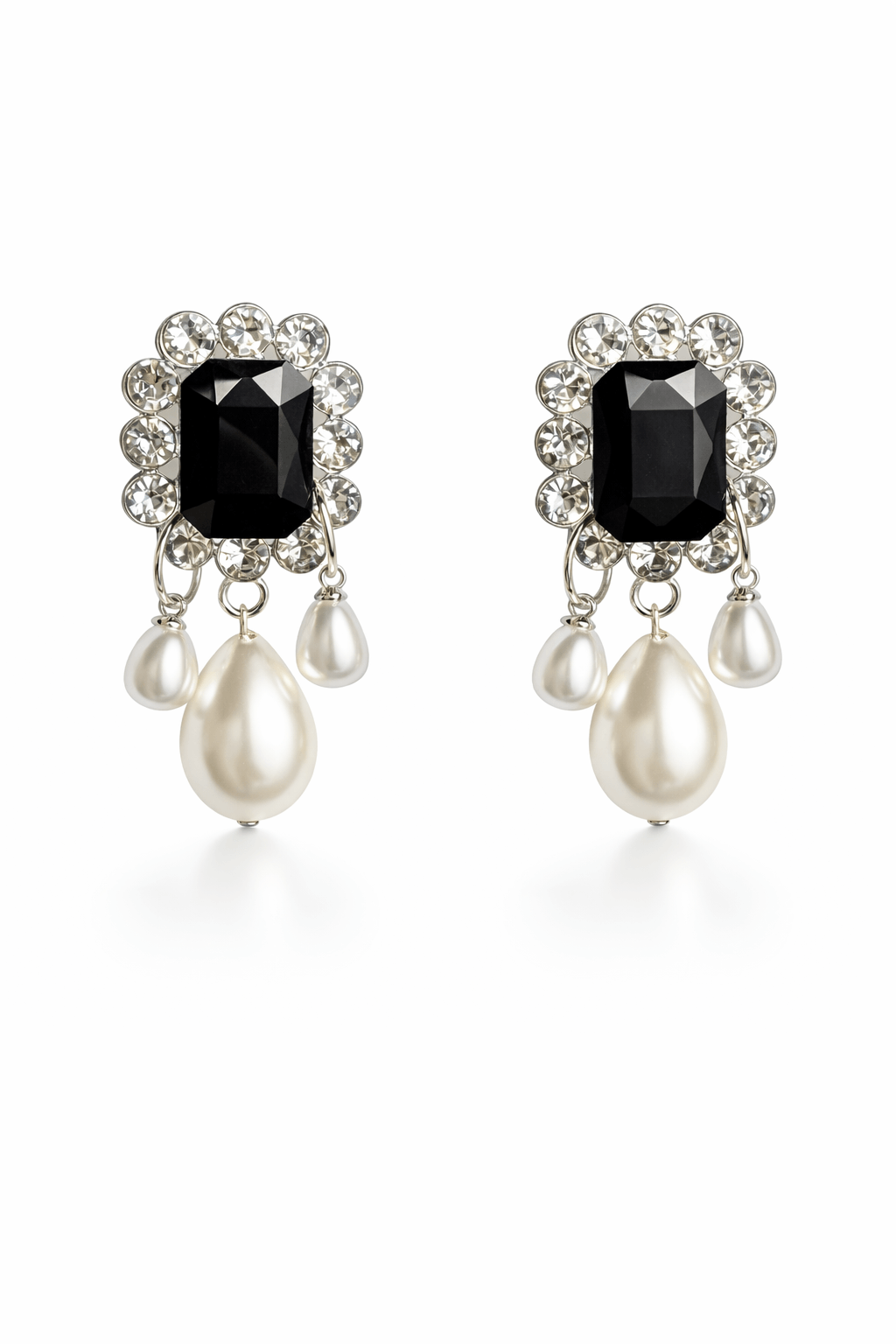 Pair of earrings with black gemstones and pearl-like drops on a white background