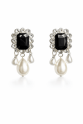 Pair of earrings with black gemstones and pearl-like drops on a white background