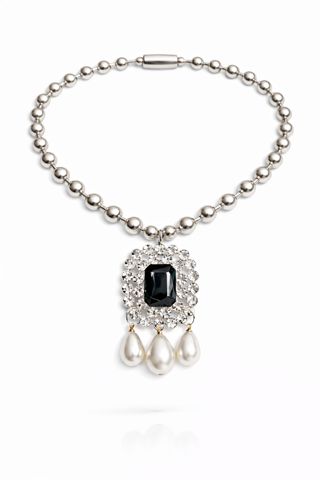 Pearl necklace with a black gemstone and pearl drops on a white background
