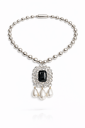 Pearl necklace with a black gemstone and pearl drops on a white background