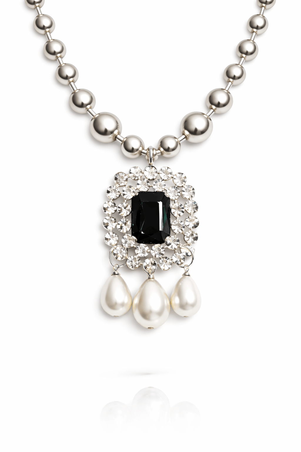 Necklace with black gemstone and pearl pendants on a white background