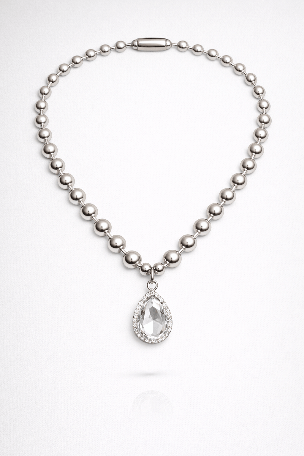 Silver necklace with a teardrop pendant on a white background