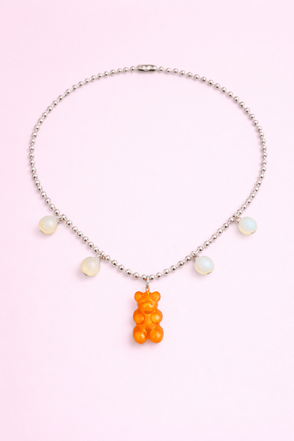 Dolce Bear Necklace with a gummy bear pendant on a pink background
