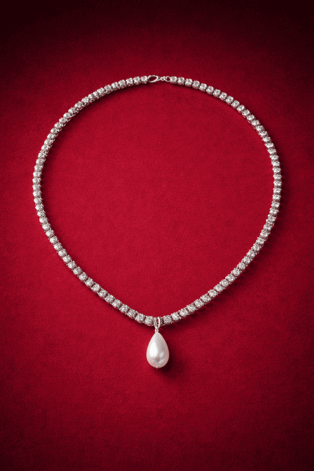 Zirconia tennis necklace with a central pearl drop on a red background, Josephine Necklace by Vintaras. 