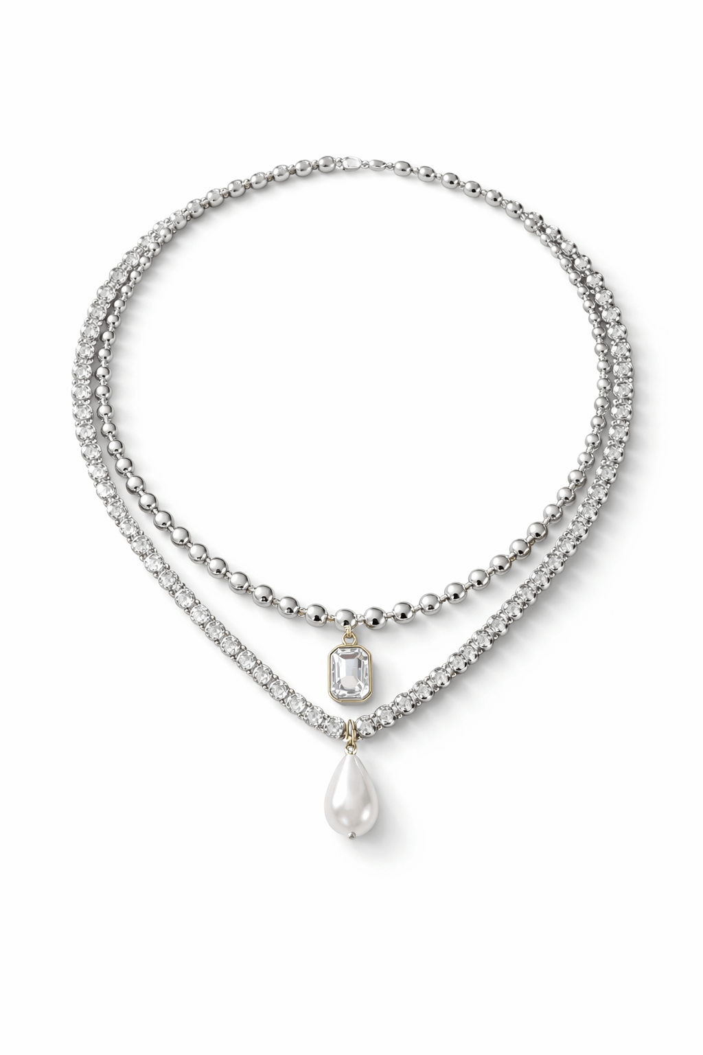 Layered necklaces, including a zirconia tennis necklace with a pearl pendant and ball chain necklace with zirconia pendant on a red background, Josephine Necklace Set by Vintaras.