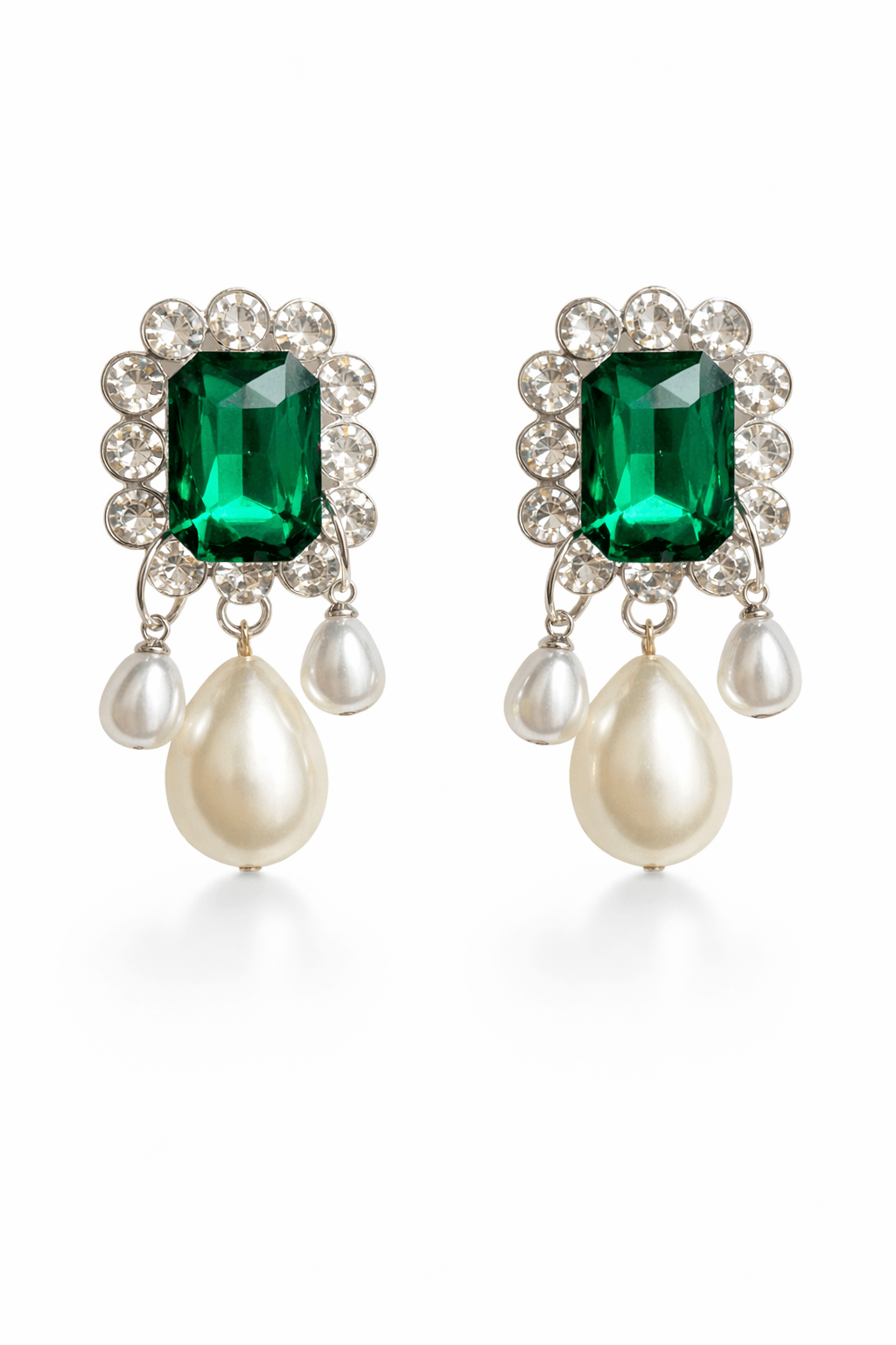 Pair of earrings with green gemstones and pearl drops on a white background
