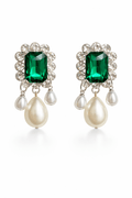 Pair of earrings with green gemstones and pearl drops on a white background