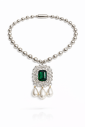 Pearl necklace with a green gemstone pendant on a white background