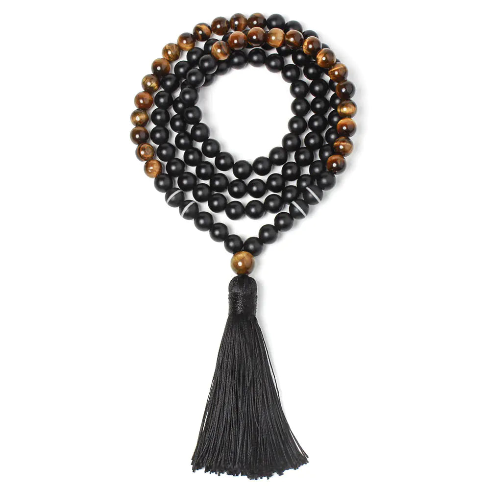 Black and brown beaded necklace with a tassel on a white background