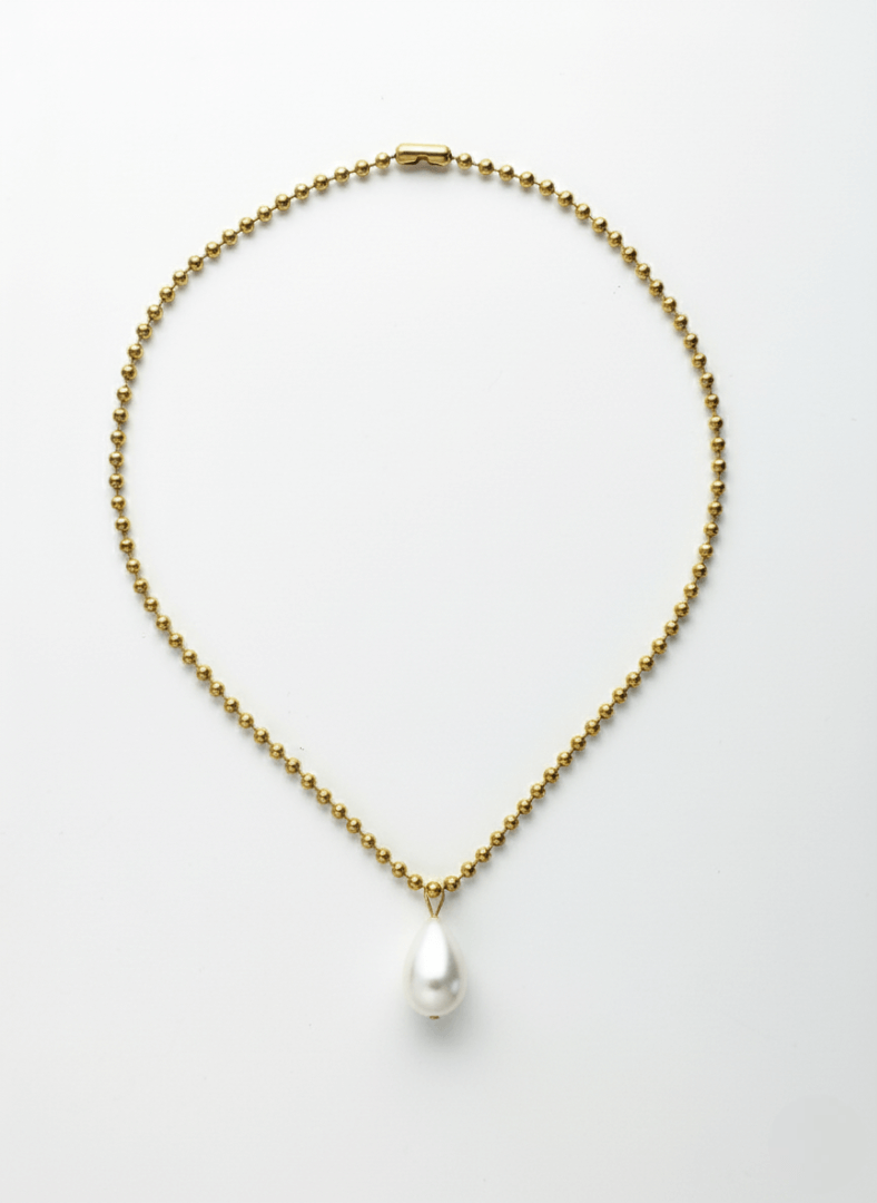 Gold necklace with a white tear drop pearl pendant, Vintaras Ingrid Necklace Gold ,  on a light gray background