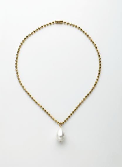 Gold necklace with a white tear drop pearl pendant, Vintaras Ingrid Necklace Gold ,  on a light gray background